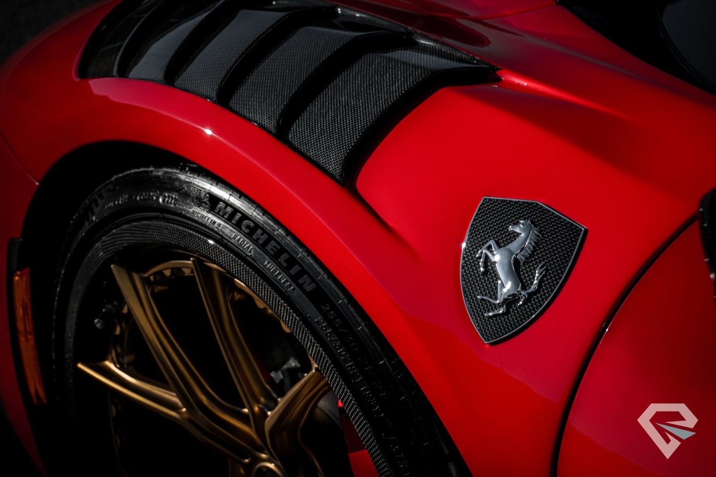 Ferrari SF90 badge and carbon fiber close-up showing ceramic coating detail